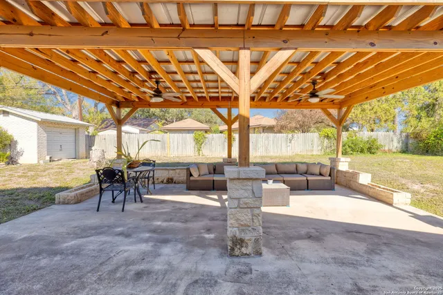 a living room with fireplace furniture and a large window
