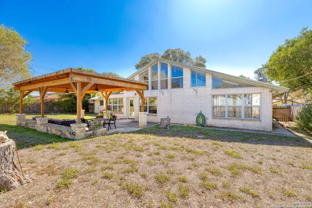 a view of a house with backyard porch and sitting area