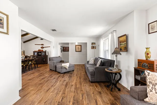 a living room with furniture and wooden floor