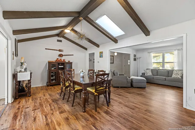 a dining room with furniture and wooden floor