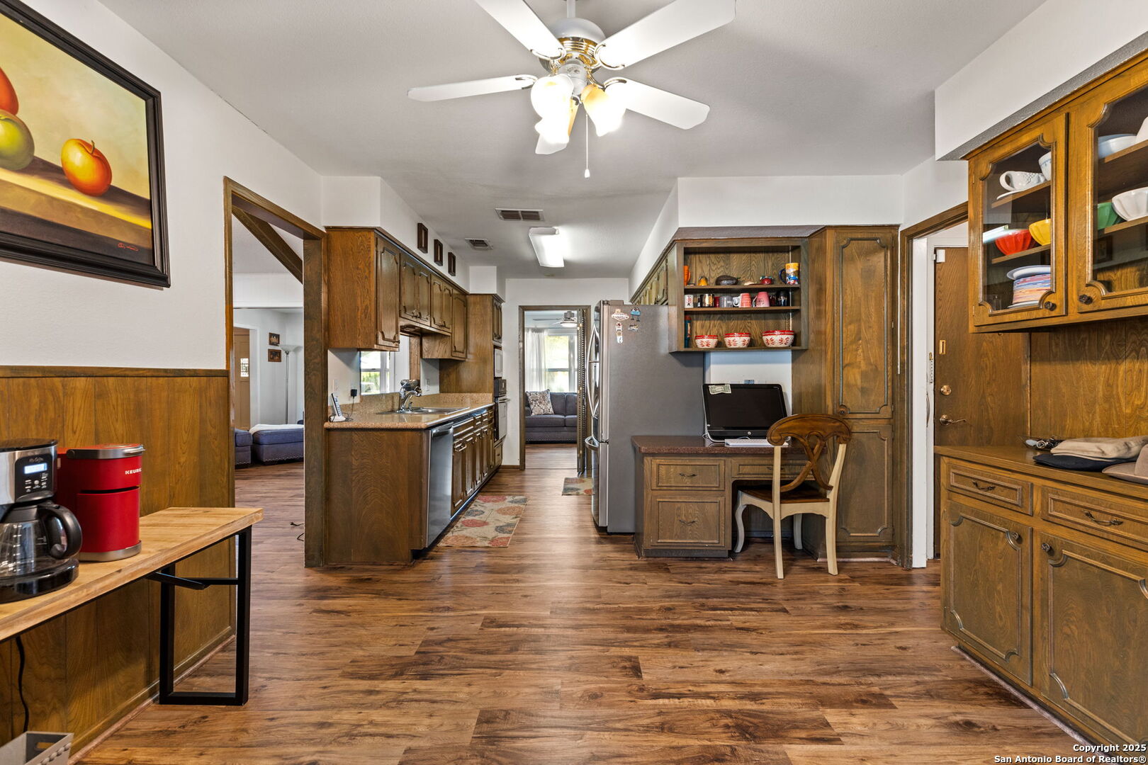713 Fawndale Lane Windcrest, TX 78239 - Photo 10 of 31 a kitchen with stainless steel appliances kitchen island granite countertop a refrigerator a stove and a dining table with wooden floor