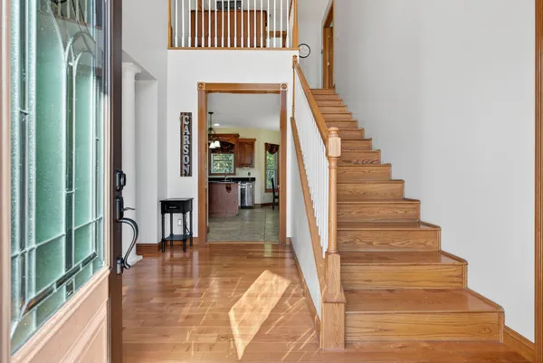 a dining room with furniture window wooden floor and a chandelier