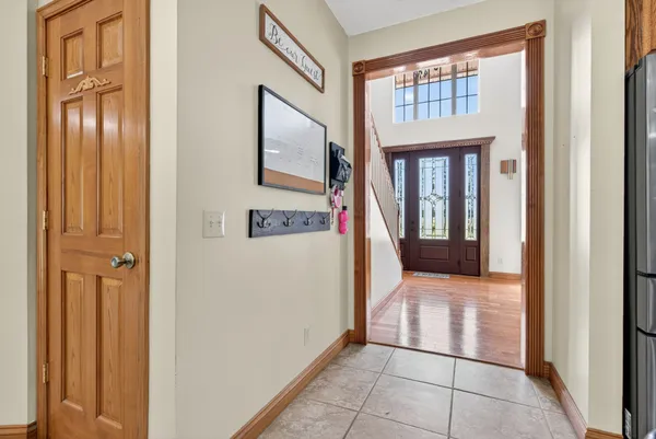 a spacious bedroom with a bed and a flat screen tv