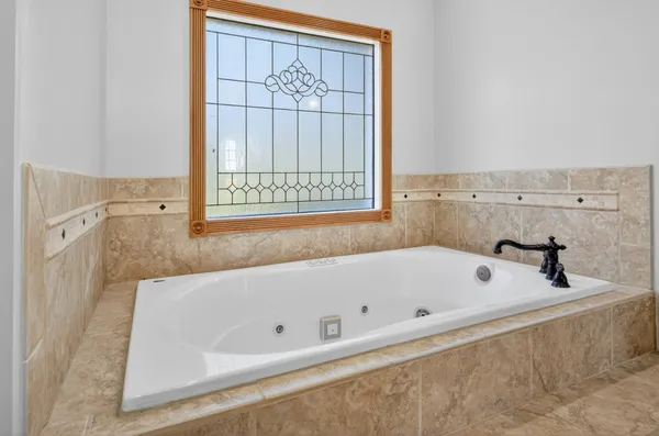 a front view of a house with a garden and plants