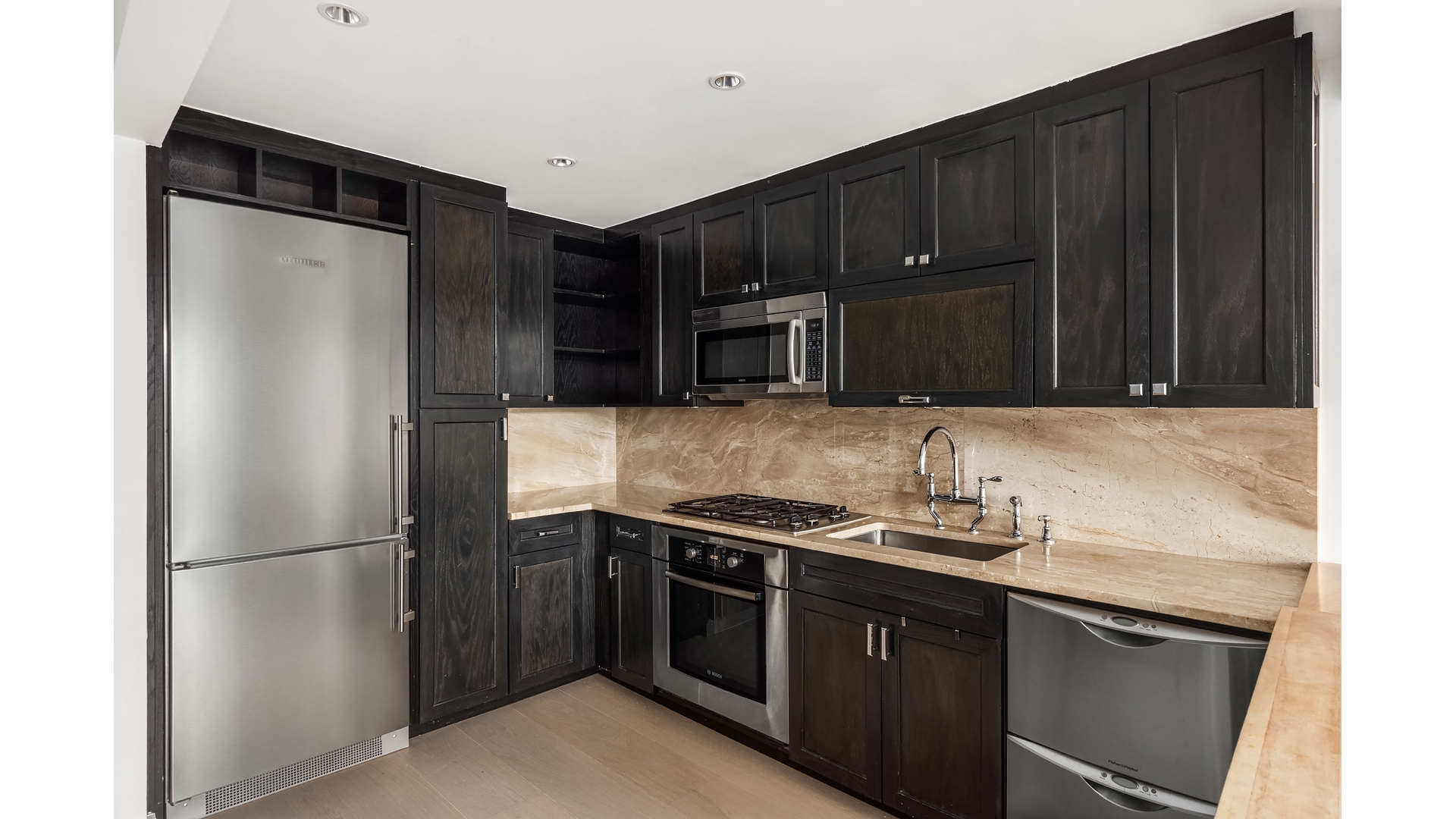333 Rector Place, Unit 907 Manhattan, NY 10280 - Photo 5 of 7 a kitchen with stainless steel appliances granite countertop a refrigerator and a sink
