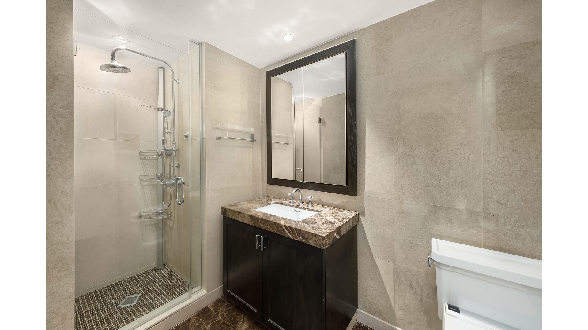333 Rector Place, Unit 907 Manhattan, NY 10280 - Photo 6 of 7 a bathroom with a granite countertop sink a toilet and shower