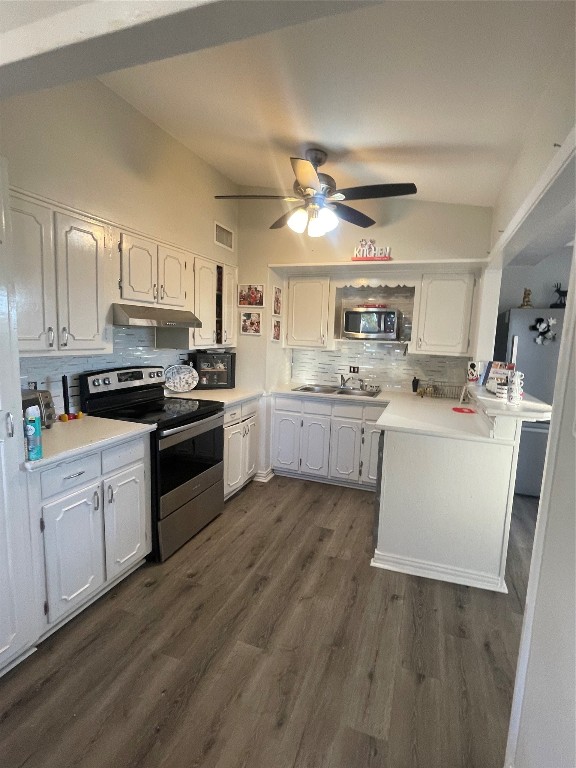 611 Sarah Street Edna, TX 77957 - Photo 11 of 31 a kitchen with stainless steel appliances a sink a stove a refrigerator cabinets and a window