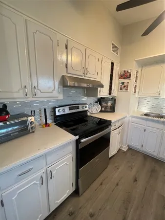 a kitchen with stainless steel appliances white cabinets and a sink