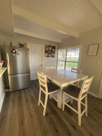 a dining room with furniture and wooden floor
