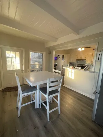 a dining room with furniture and wooden floor