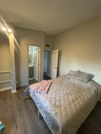 a bedroom with a bed and a dresser