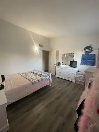 a bedroom with a bed and a night stand