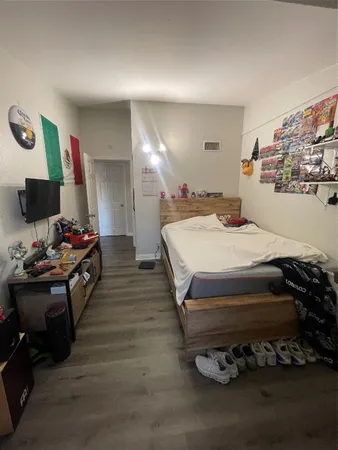 a bed room with a bed and a computer