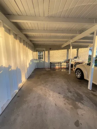 a view of a car garage bed and a car parked in a parking