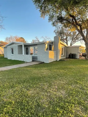 a view of a house with a big yard and large trees