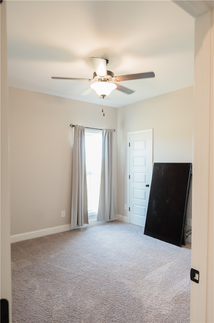 116 Public Well Road Anderson, SC 29626 - Photo 13 of 19 An inviting room features a prominent ceiling fan, clean carpeting, and natural light.