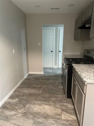 a kitchen with a stove and a refrigerator