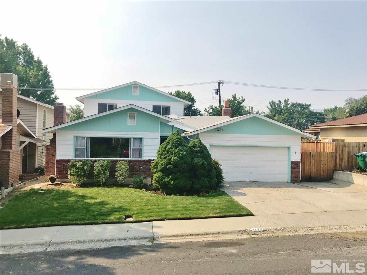 2130 Prince Way Reno, NV 89503 - Photo 1 of 25 a front view of a house with a yard and garage