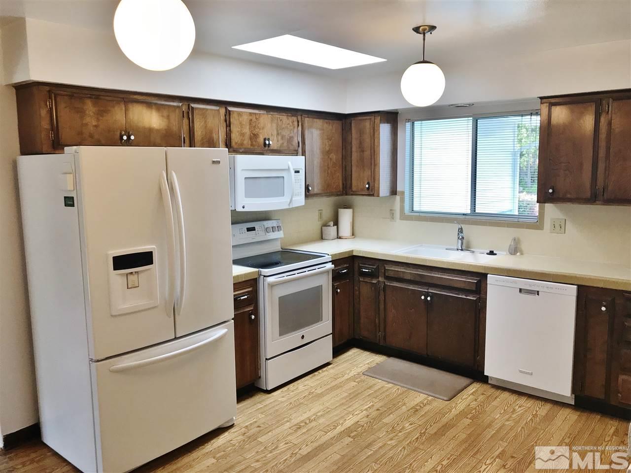 2130 Prince Way Reno, NV 89503 - Photo 6 of 25 a kitchen with a refrigerator sink and cabinets