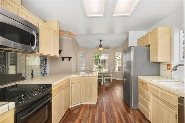 a kitchen with stainless steel appliances granite countertop a sink stove and refrigerator