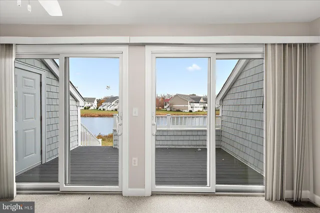 a white kitchen with granite countertop white cabinets and white appliances