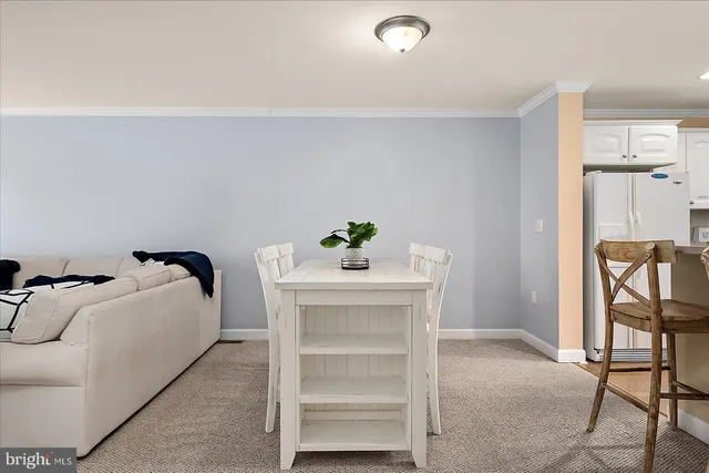 a spacious bedroom with a bed a lamp and a chandelier