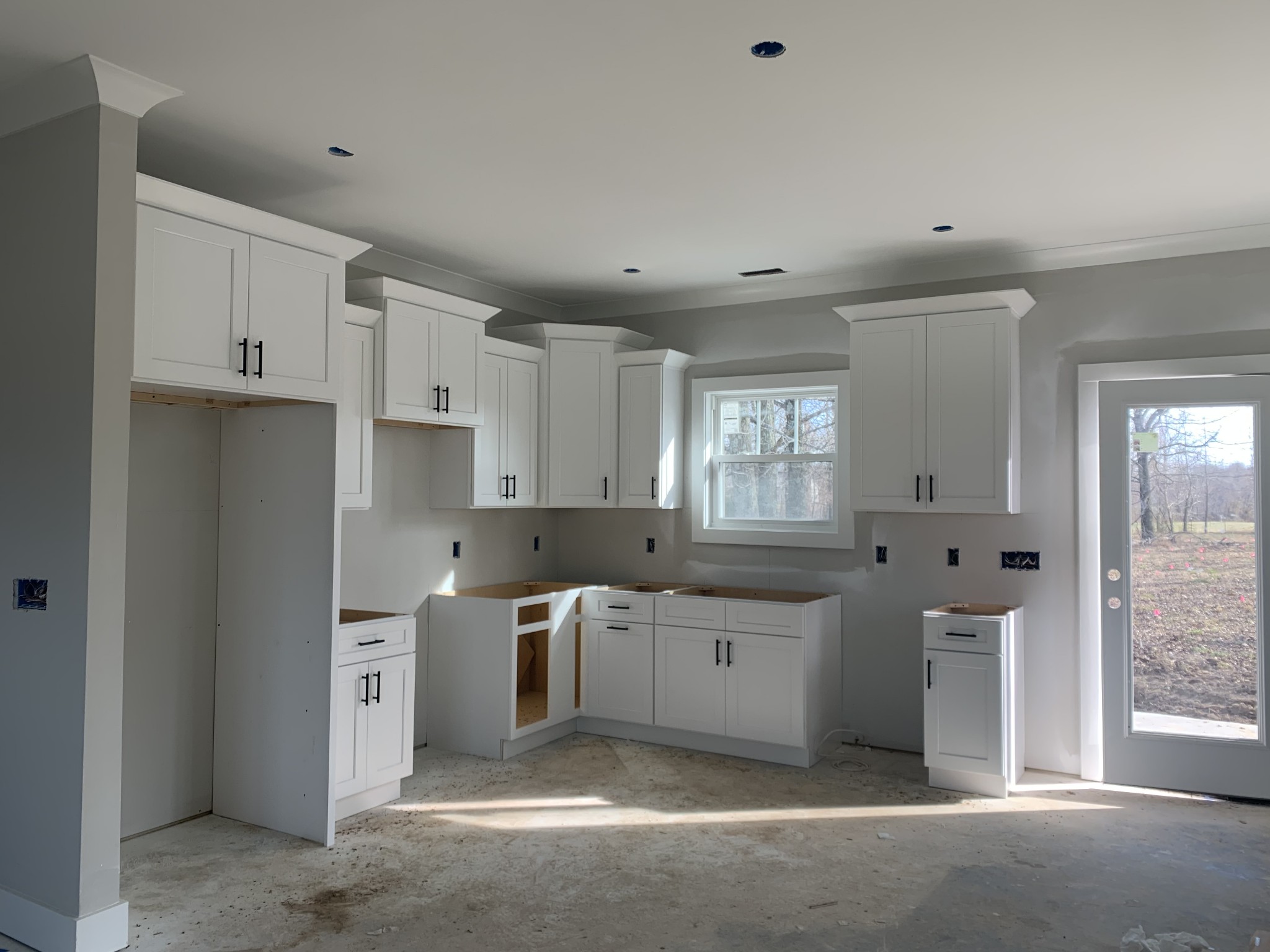 5249 Hugh Woodard Road Springfield, TN 37172 - Photo 3 of 11 a large white kitchen with stainless steel appliances granite countertop lots of white cabinets and a sink