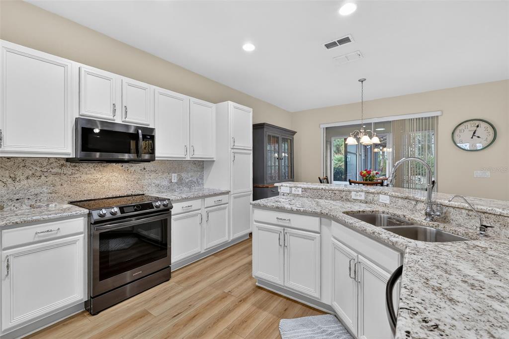 9611 Southwest 71st Loop Ocala, FL 34481 - Photo 14 of 31 a kitchen with a sink stove and microwave