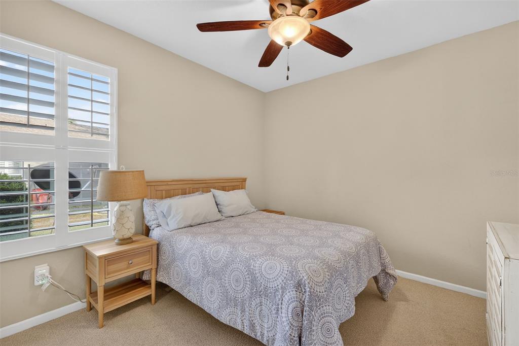 9611 Southwest 71st Loop Ocala, FL 34481 - Photo 20 of 31 a bedroom with a bed and a chandelier