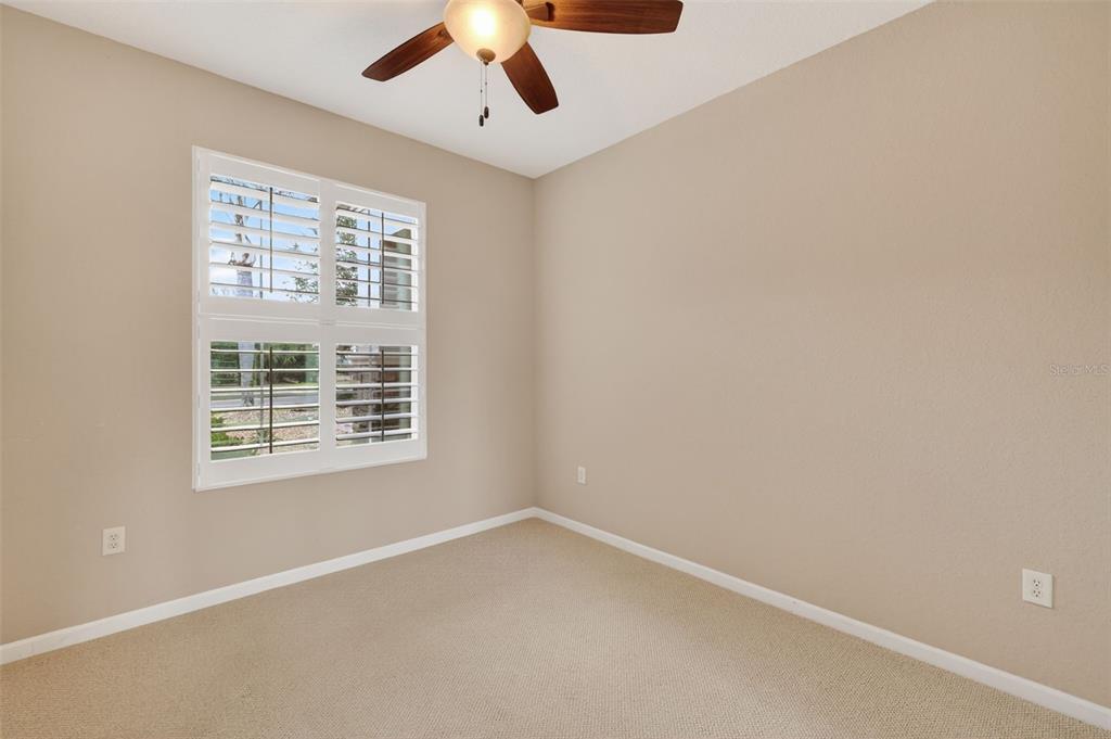 9611 Southwest 71st Loop Ocala, FL 34481 - Photo 21 of 31 an empty room with a window and a ceiling fan