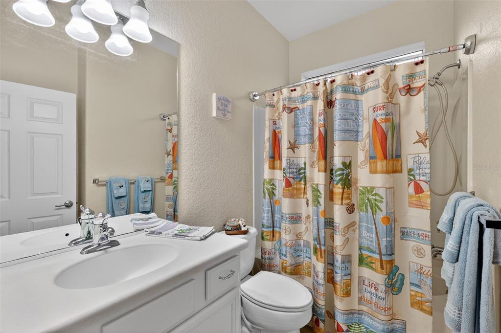 9611 Southwest 71st Loop Ocala, FL 34481 - Photo 23 of 31 a bathroom with a sink a toilet a mirror a vanity and shower