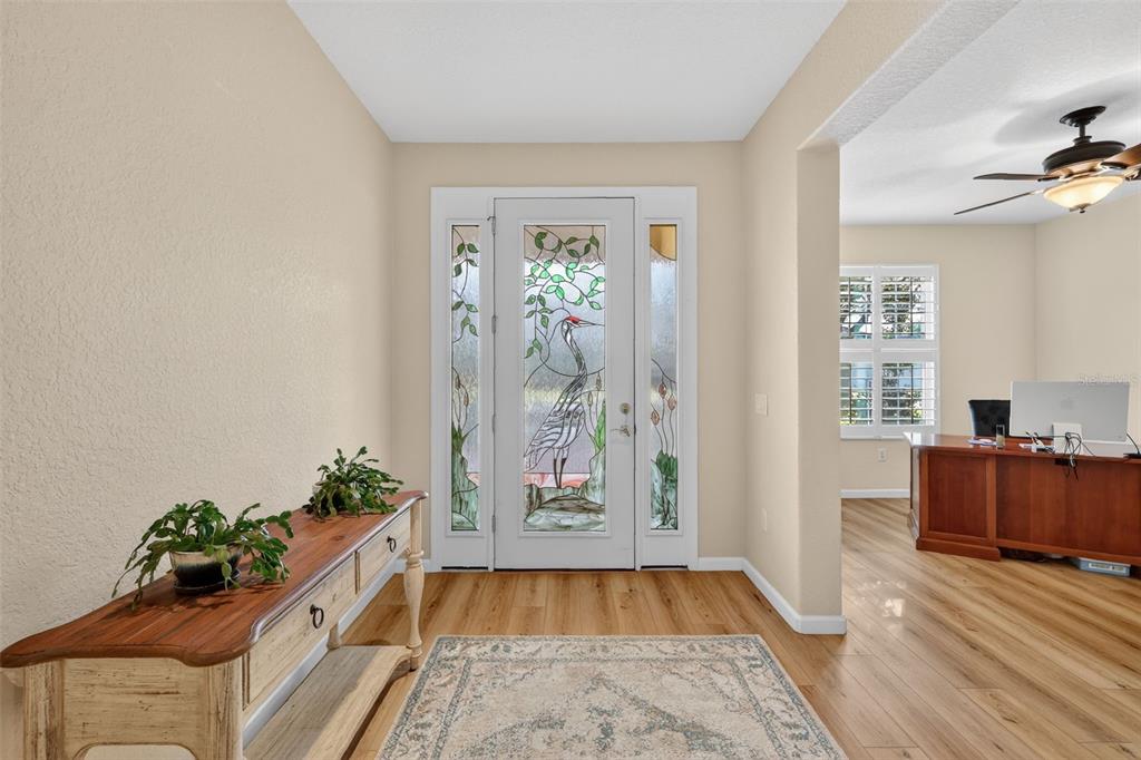 9611 Southwest 71st Loop Ocala, FL 34481 - Photo 5 of 31 a room with painting on the wall and a potted plant