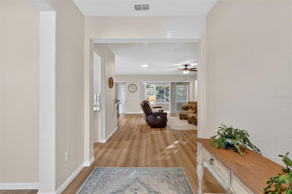 9611 Southwest 71st Loop Ocala, FL 34481 - Photo 6 of 31 a view of a bedroom with wooden floor and furniture