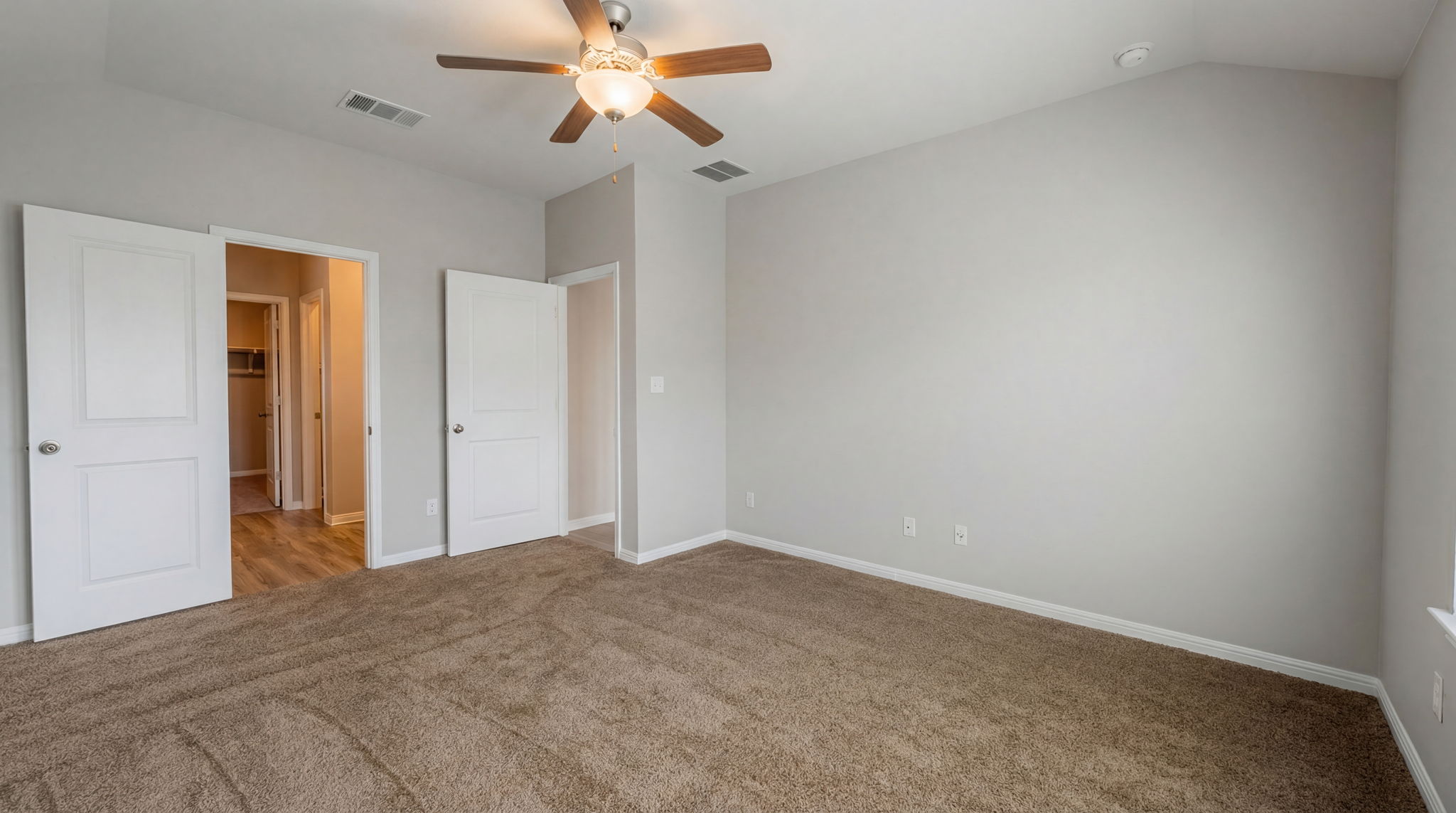 1003 Round Bale Road Hutto, TX 78634 - Photo 28 of 29 Unfurnished bedroom featuring carpet floors, a ceiling fan, and lofted ceiling