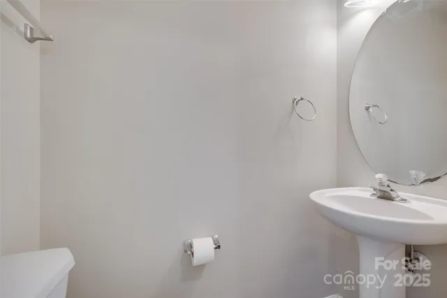 a bathroom with a sink toilet and a mirror