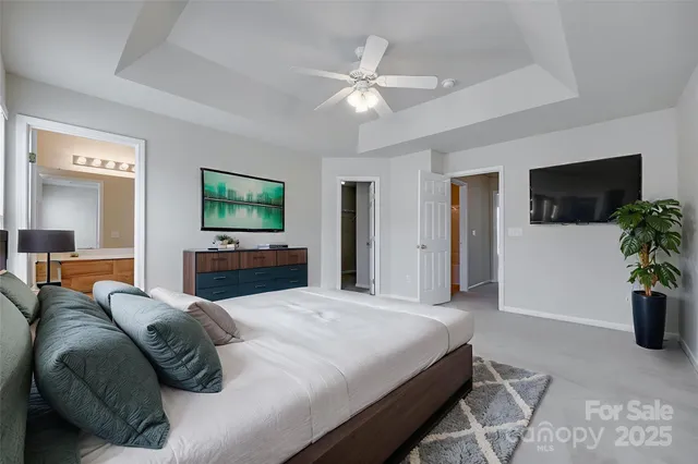 a bedroom with a large bed and a flat screen tv