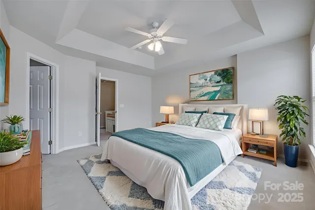 a bedroom with a large bed and a chandelier
