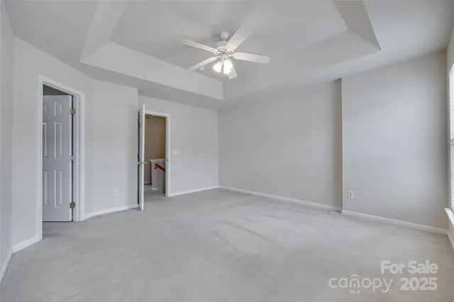 a view of an empty room with a ceiling fan