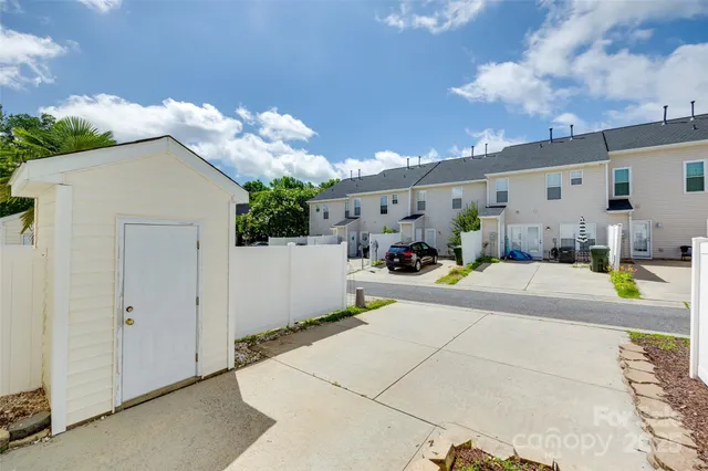 a view of a patio with table and chairs under an umbrella