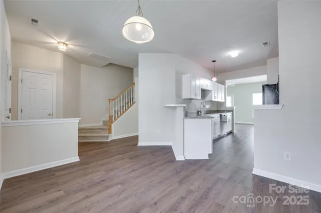 a view of kitchen with cabinets and wooden floor