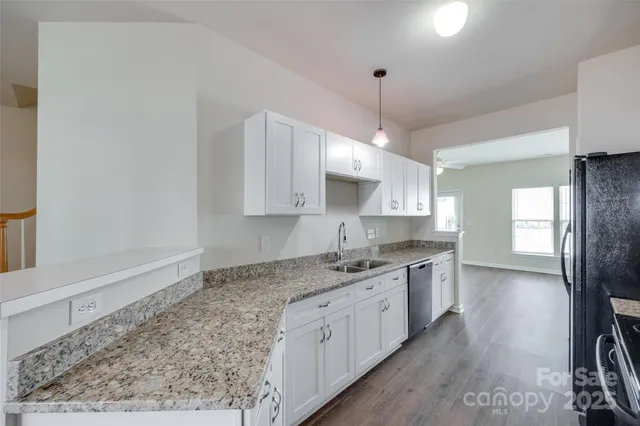 a kitchen with a sink stove and cabinets