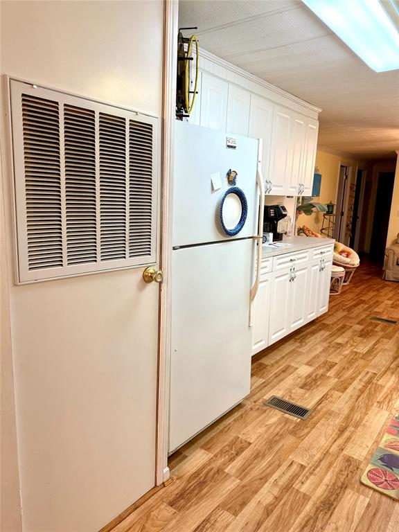1589 Airport Loop Homer, LA 71040 - Photo 7 of 15 a kitchen with a refrigerator and white cabinets