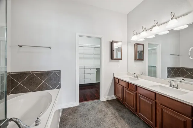 a bathroom with a bathtub and shower