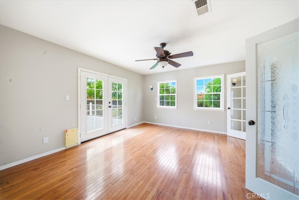 6481 Dos Rios Road Downey, CA 90240 - Photo 19 of 27 a view of an empty room with a window and wooden floor