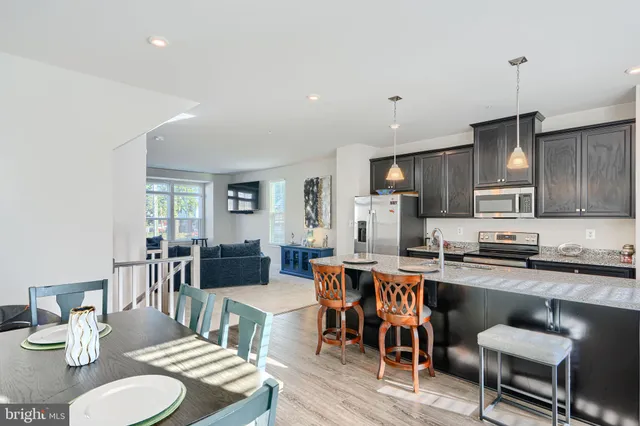a large kitchen with a table and chairs