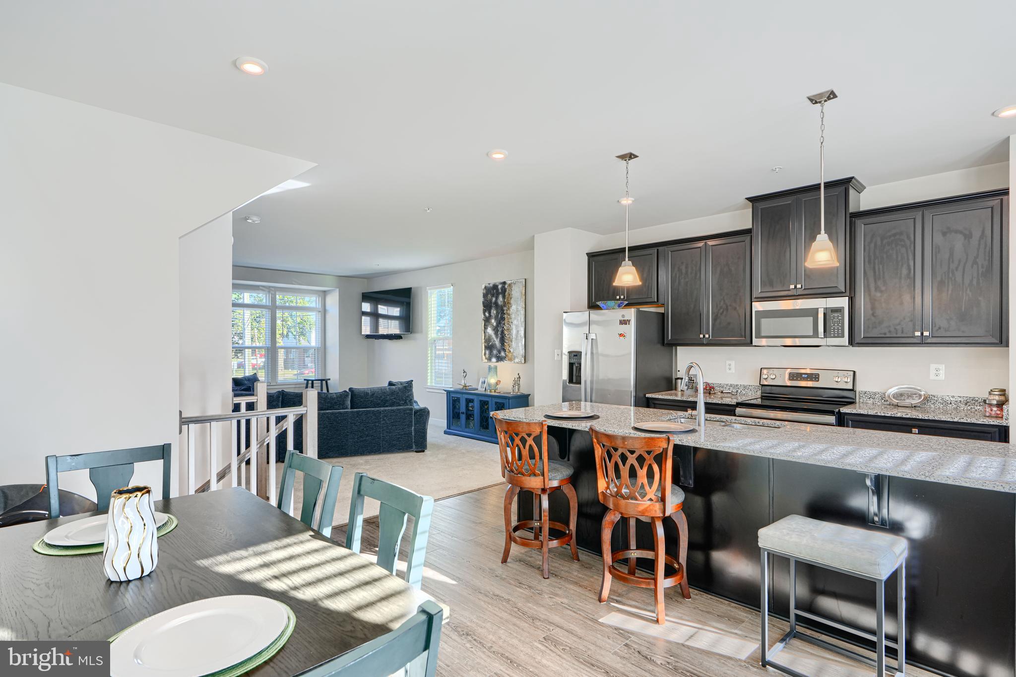 a large kitchen with a table and chairs