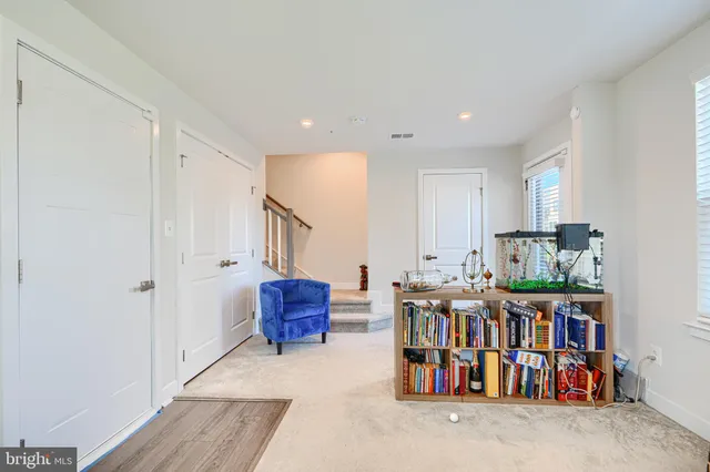 a room with lots of furniture and baby crib