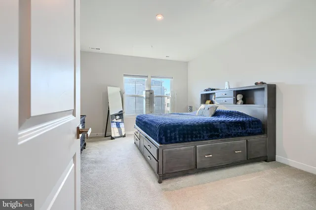 a living room with a bed and furniture with window