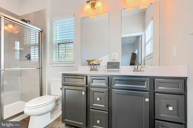 a bathroom with a sink toilet and mirror