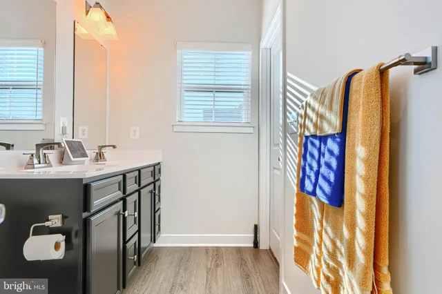 a bathroom with a sink mirror and tub
